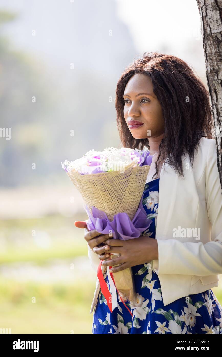 Portrait of beautiful black woman with flowers Stock Photo Alamy