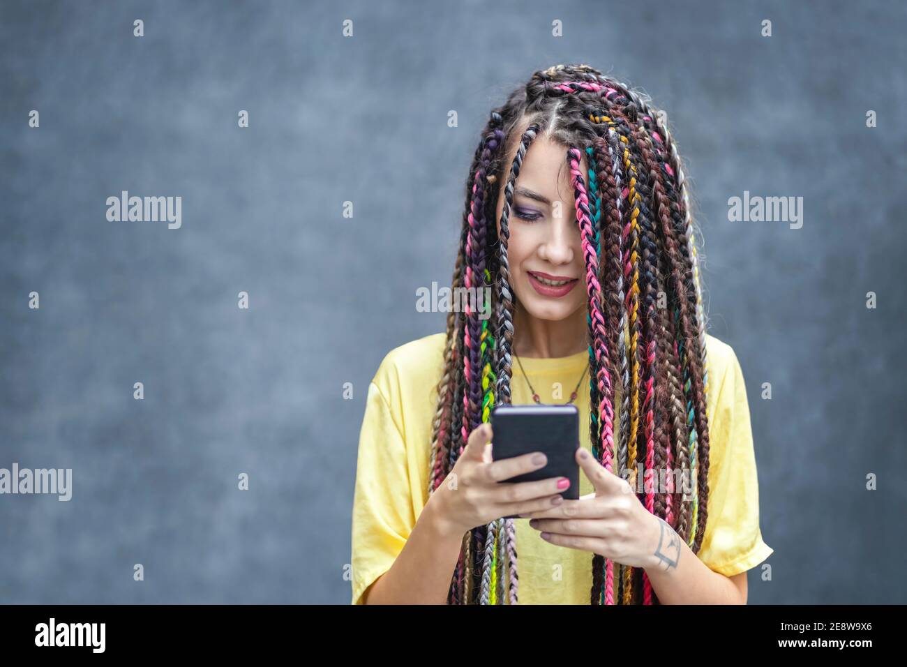 Happy millennial girl using mobile phone app for social media Stock Photo