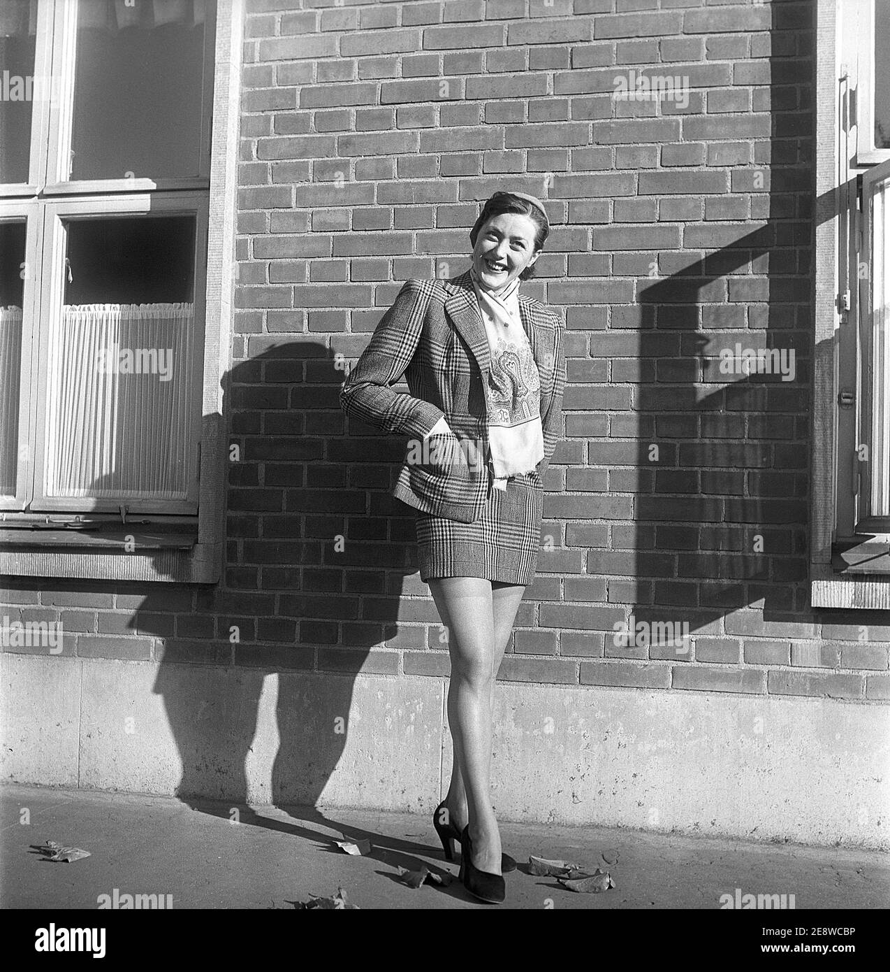 Nylon stockings in the 1950s. The model Solveij Nyhlén pictured outside the swedish factory of nylon stockings, Malmö strumpfabrik. Established 1926 and became the leading manufacturer of silk stockings in sweden. At this time 1951 the company had invested in new machinery to make the popular nylon stockings. Ref BE20-3 Stock Photo