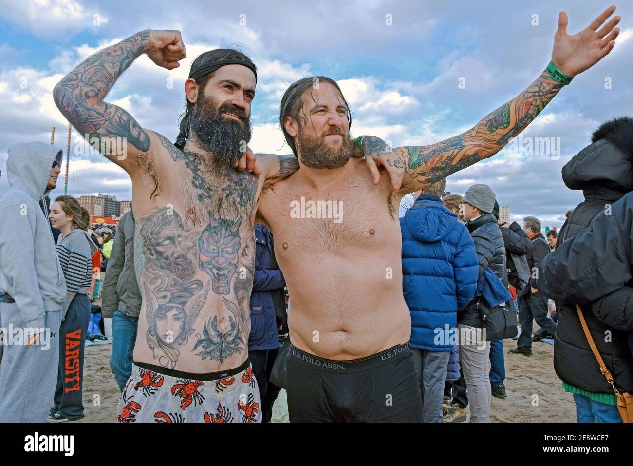 2 swimmers emerge from the water after participating in the annual Polar Bear Club New Years Day winter swim. In Coney Island, Brooklyn, NY, 2016. Stock Photo