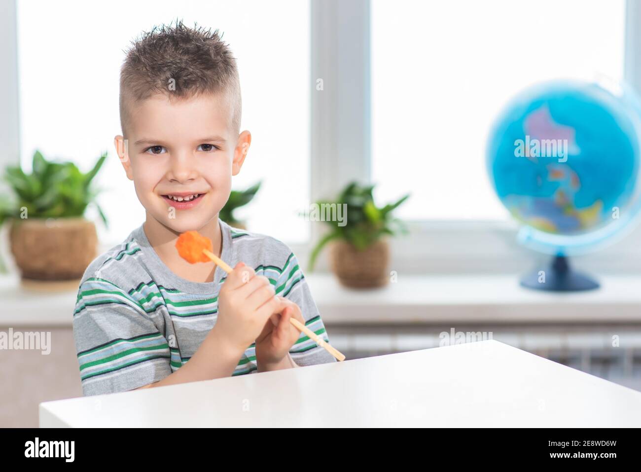 Little Girl Munching On A Carrot Stick Holding Bowl Of Vegetables Stock  Photo, Picture and Royalty Free Image. Image 11411207.