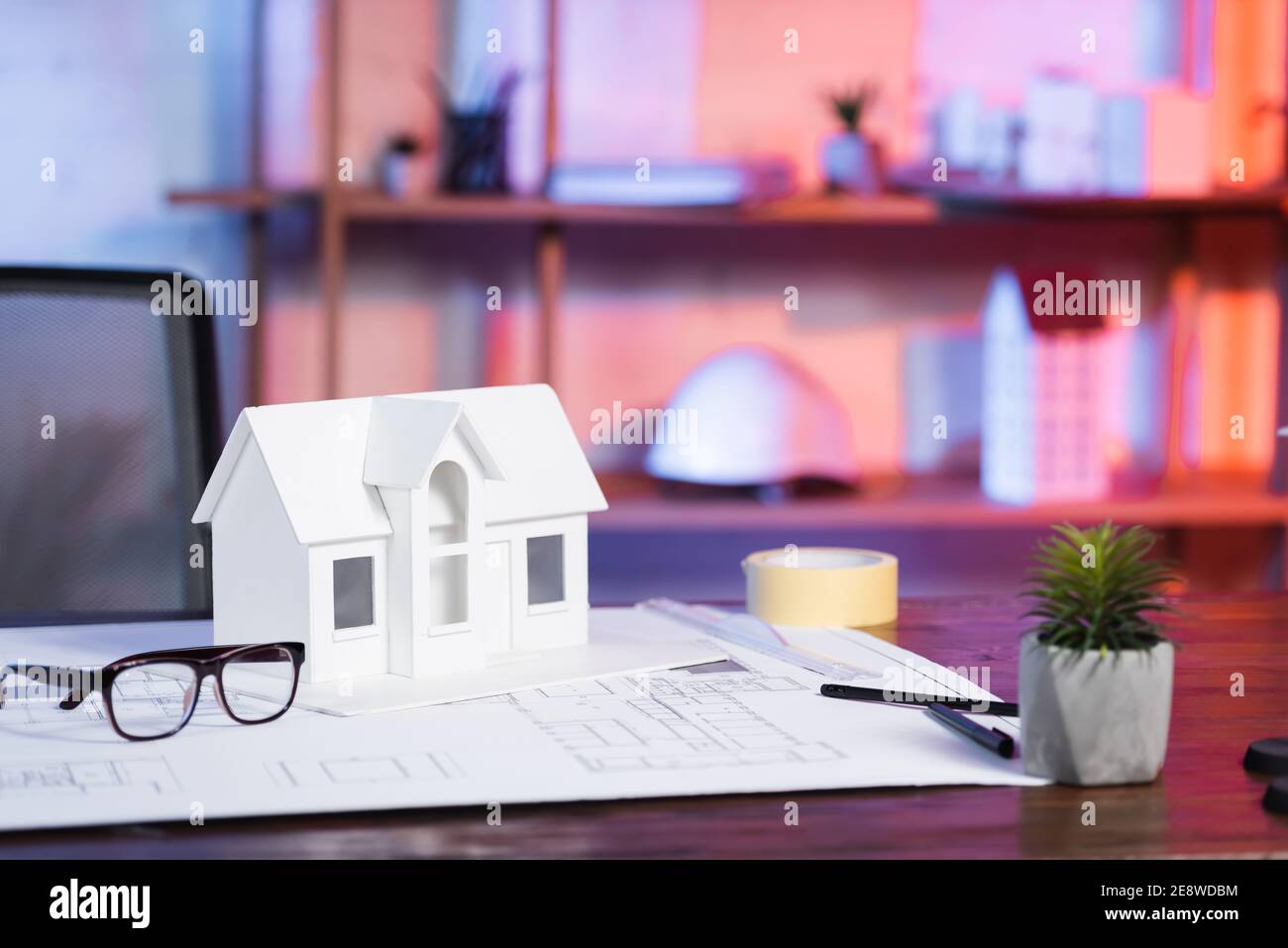house model near blueprint and eyeglasses on desk in architectural agency Stock Photo