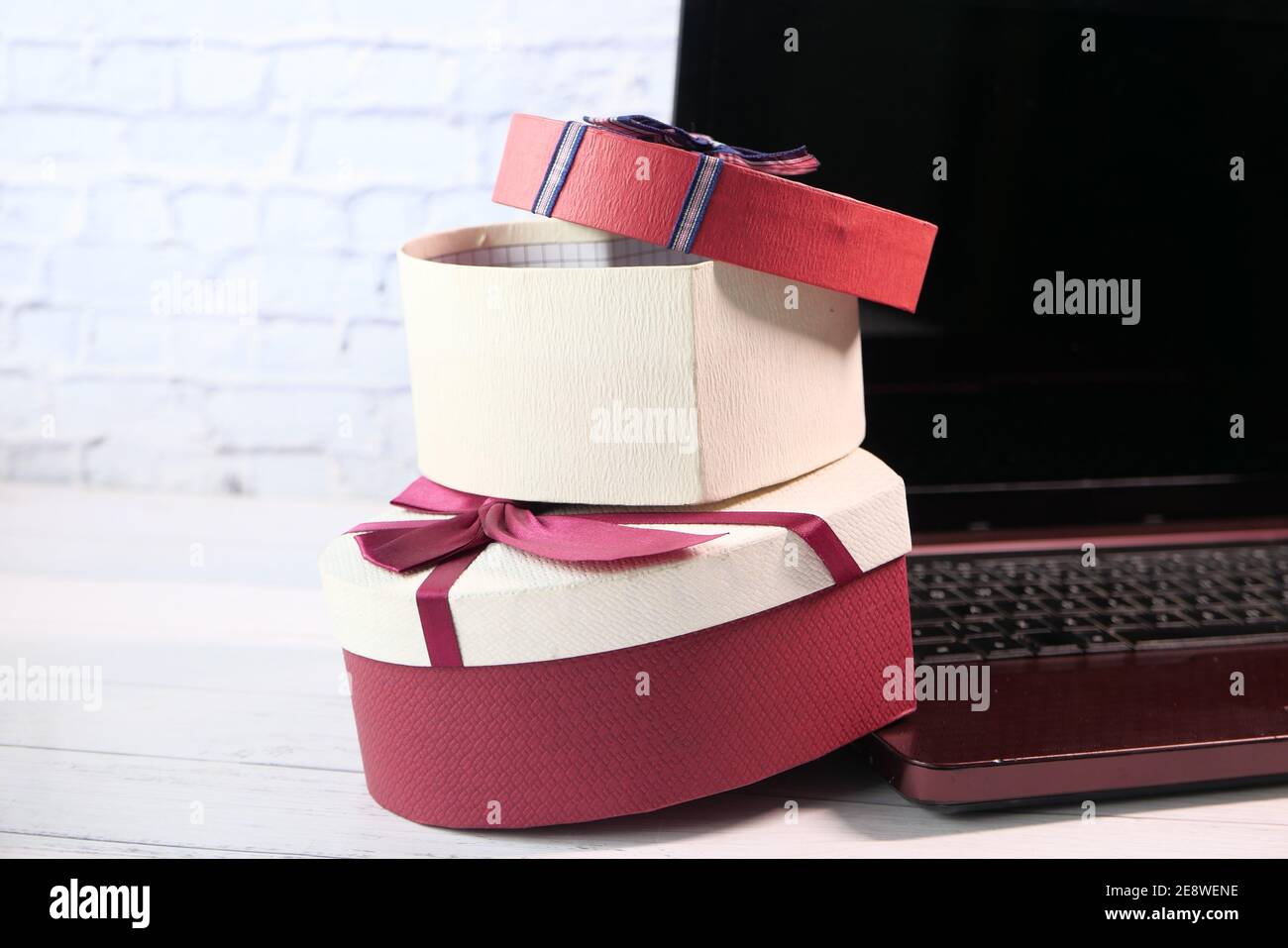stack of gift box and laptop on table  Stock Photo