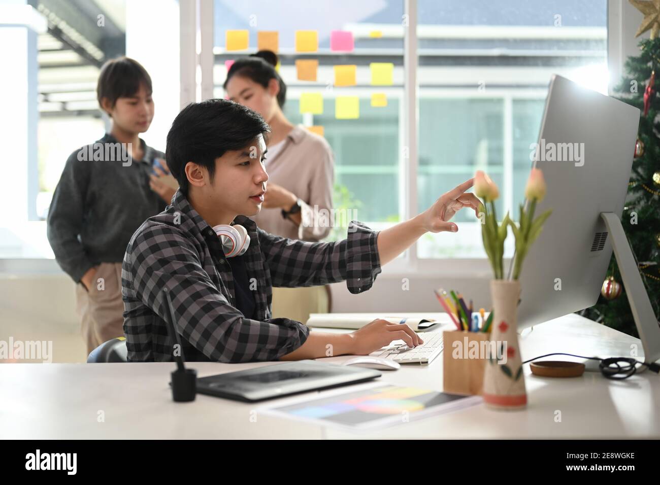 Creative designer team brainstorming and using modern devices in office ...
