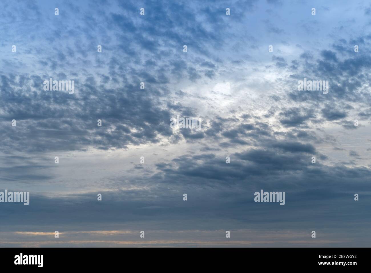 sunset with blue fluffy cloudy sky, sunset background Stock Photo - Alamy