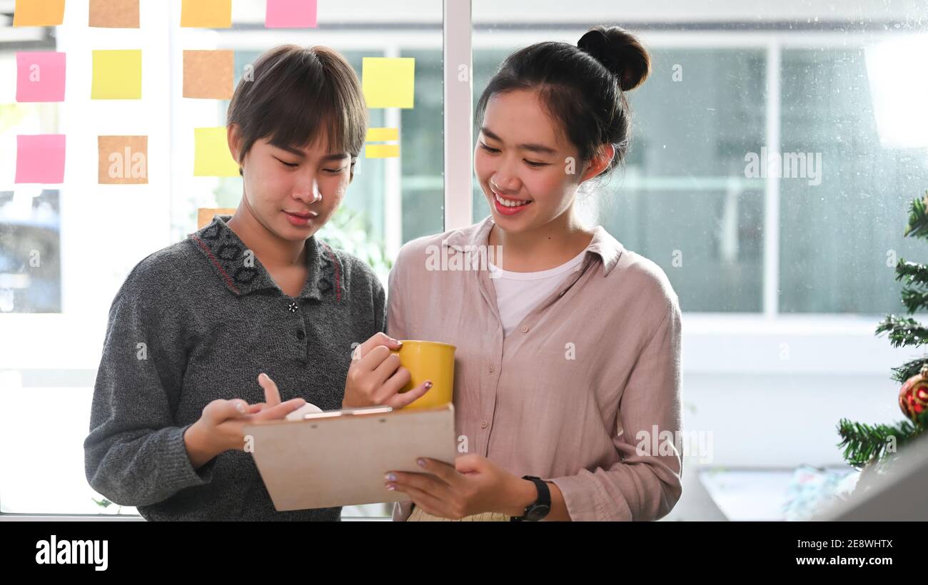 Two designers colleagues discussing new project in creative office. Stock Photo
