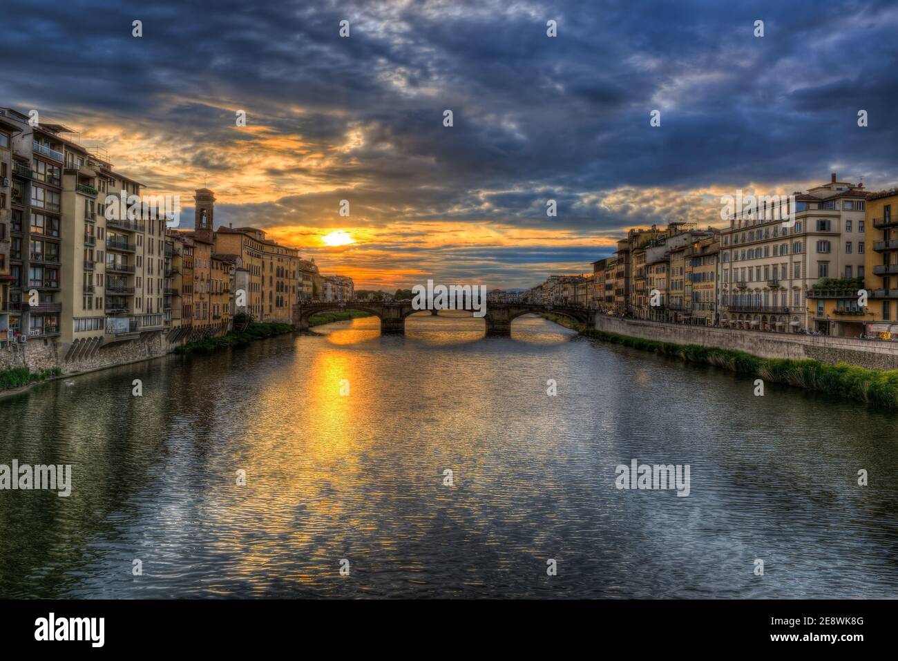 being in the middle of the ponte Vecchio and looking toward the Arno during a glorious florentine sunset Stock Photo