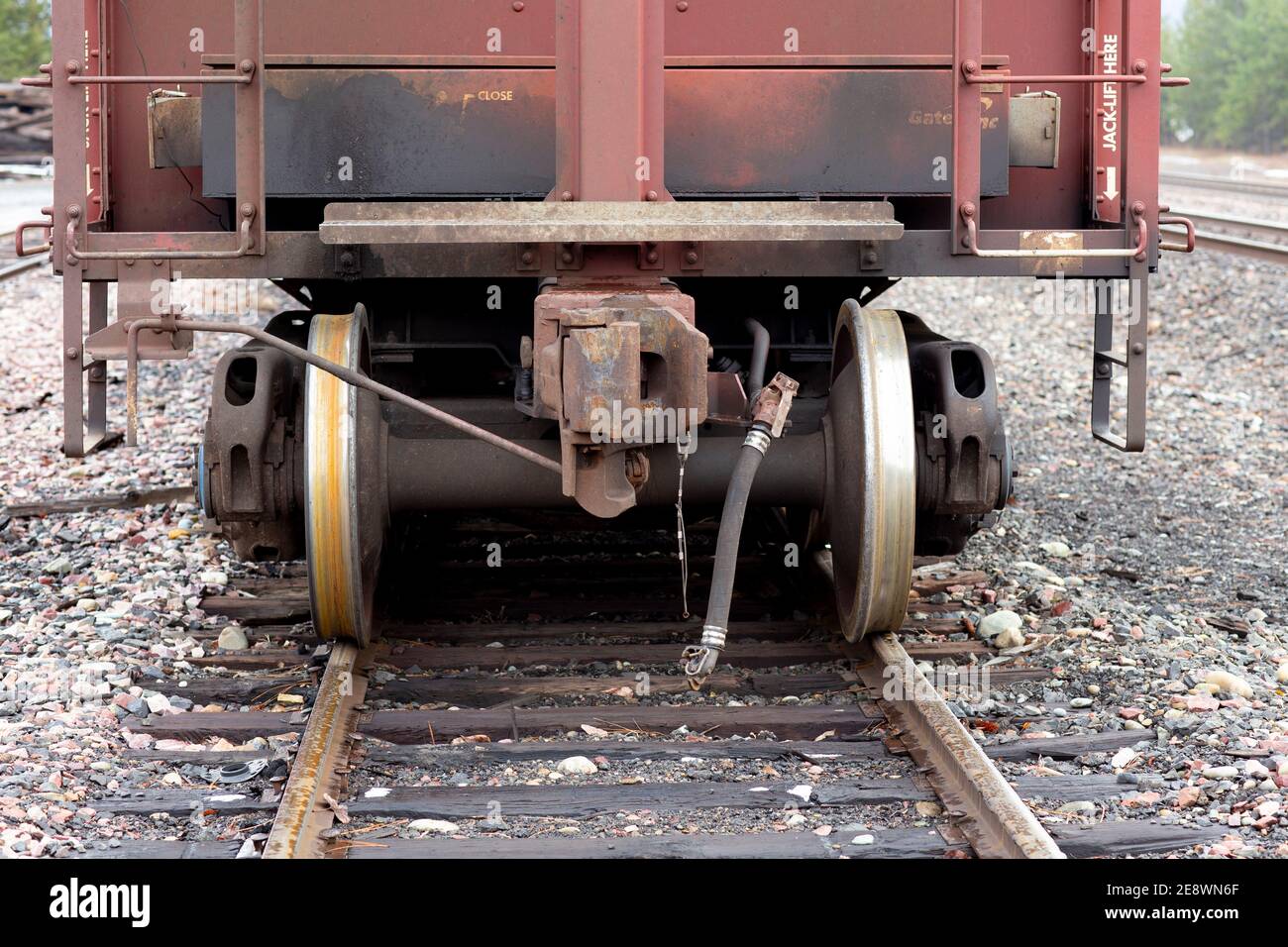 Railroad hopper car coupler, and truck wheels and axles, on the tracks, at the BNSF railroad yard, Troy, Montana.   Burlington Northern and Santa Fe R Stock Photo