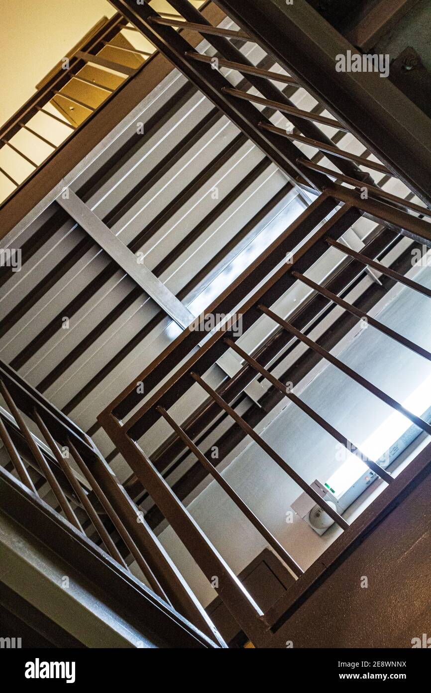 The lines of steps and railings in a stairwell create an abstract design. Stock Photo