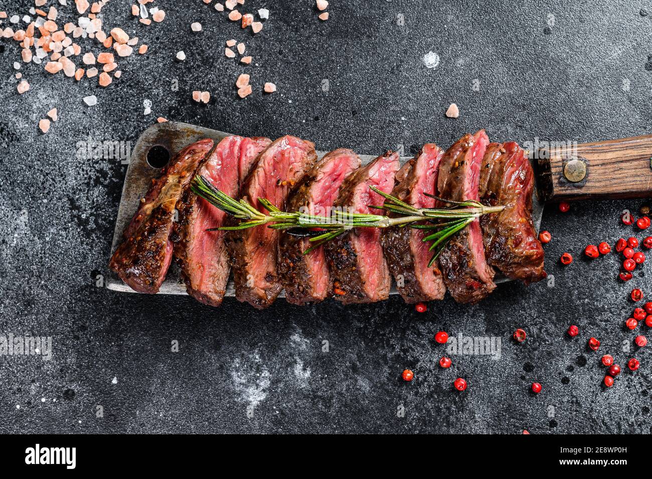 Grilled Vegas strip steak. Marble meat beef. Black background. Top view