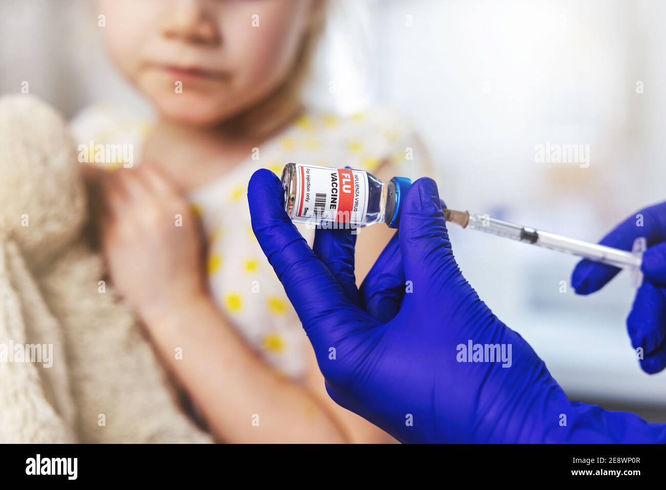 flu vaccine. doctor fill the syringe from vial for child vaccination Stock Photo