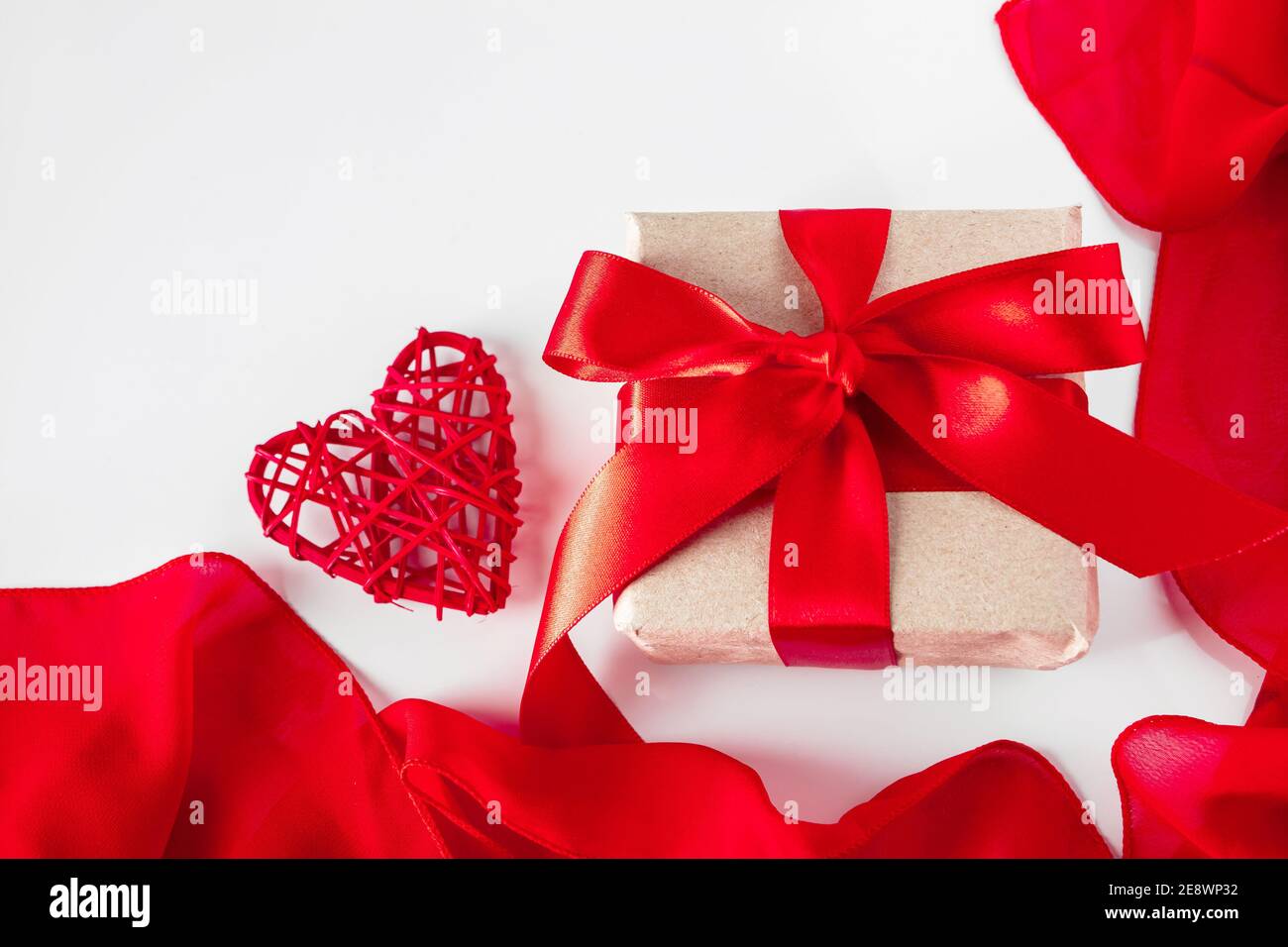Gift box with craft paper and red ribbon on white background Stock ...