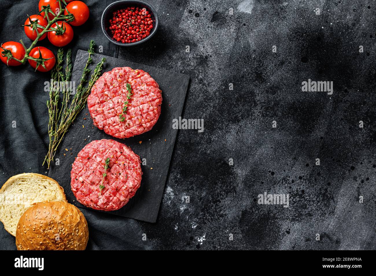 Ingredients for cooking burgers. Minced beef patties, buns, tomatoes