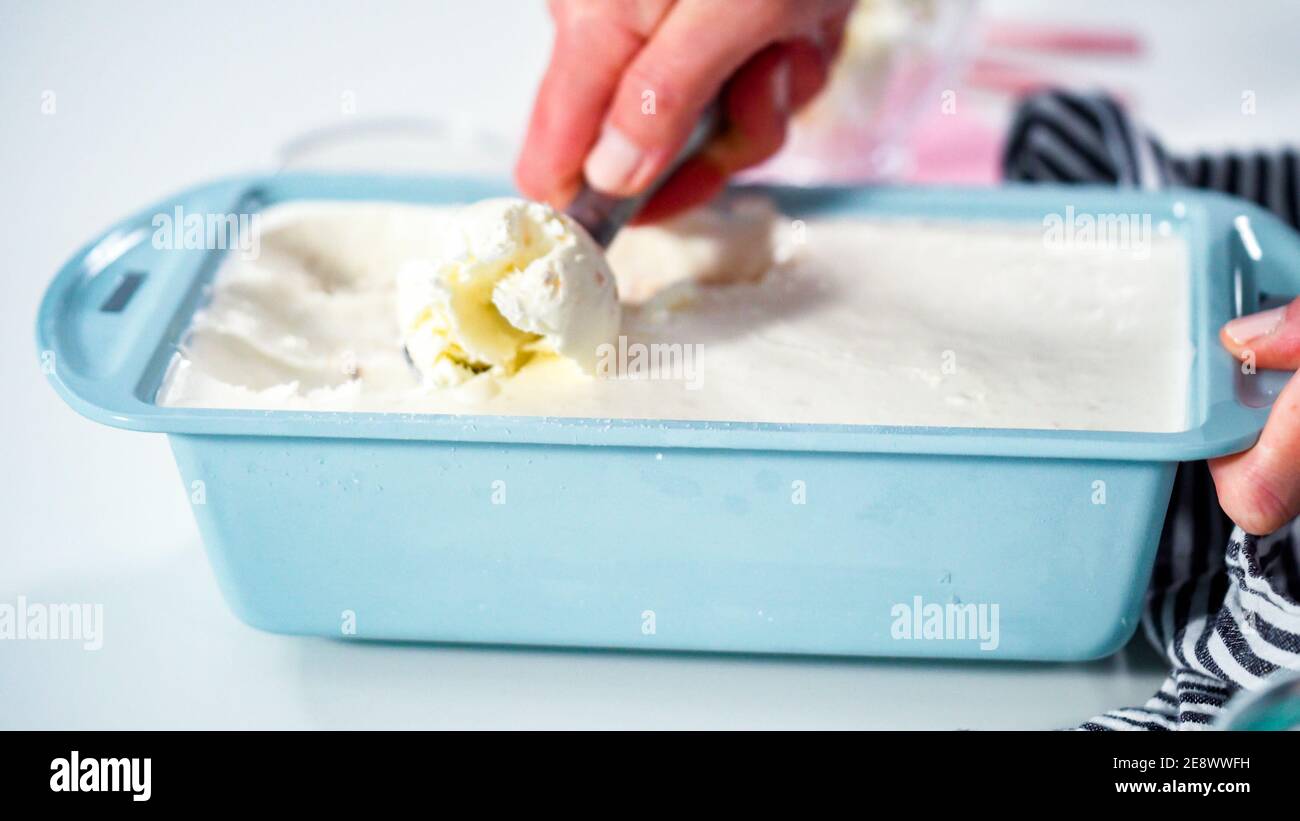 Scooping homemade coconut ice cream into a glass ice cream bowl Stock Photo Alamy