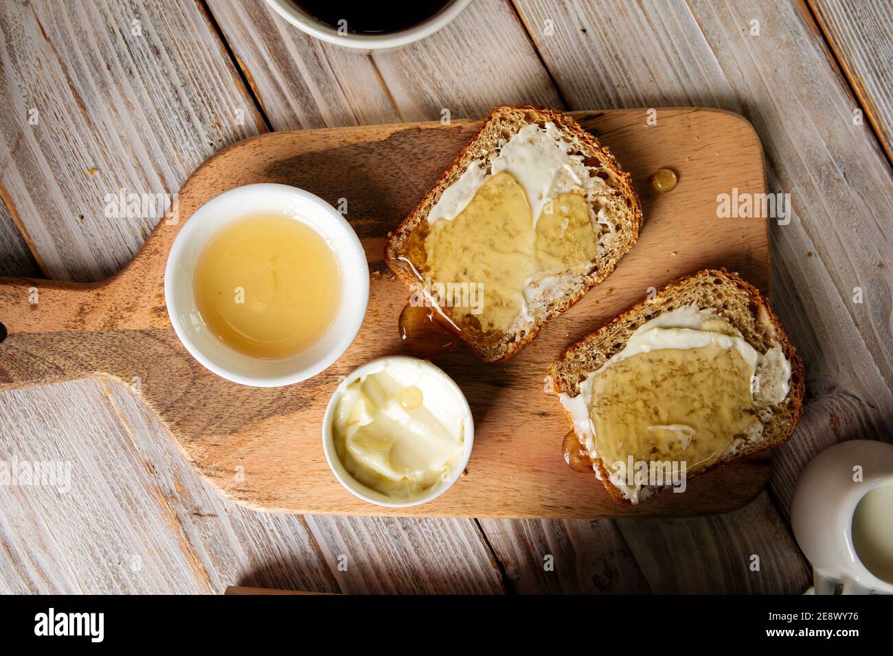 Whole grain bread slices with butter and honey Stock Photo - Alamy