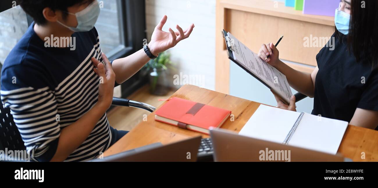 Female psychiatrist talking with with her patient in medical clinic or