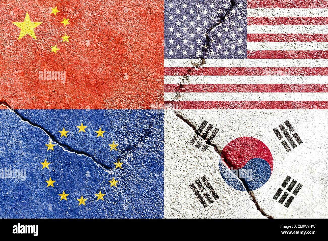 Closeup of USA, China, EU, and South Korea flags on weathered and cracked wall background Stock Photo
