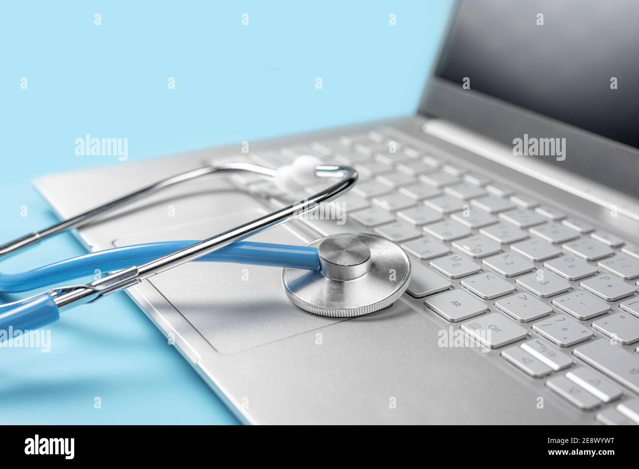 Stethoscope keyboard laptop computer isolated on blue background ...