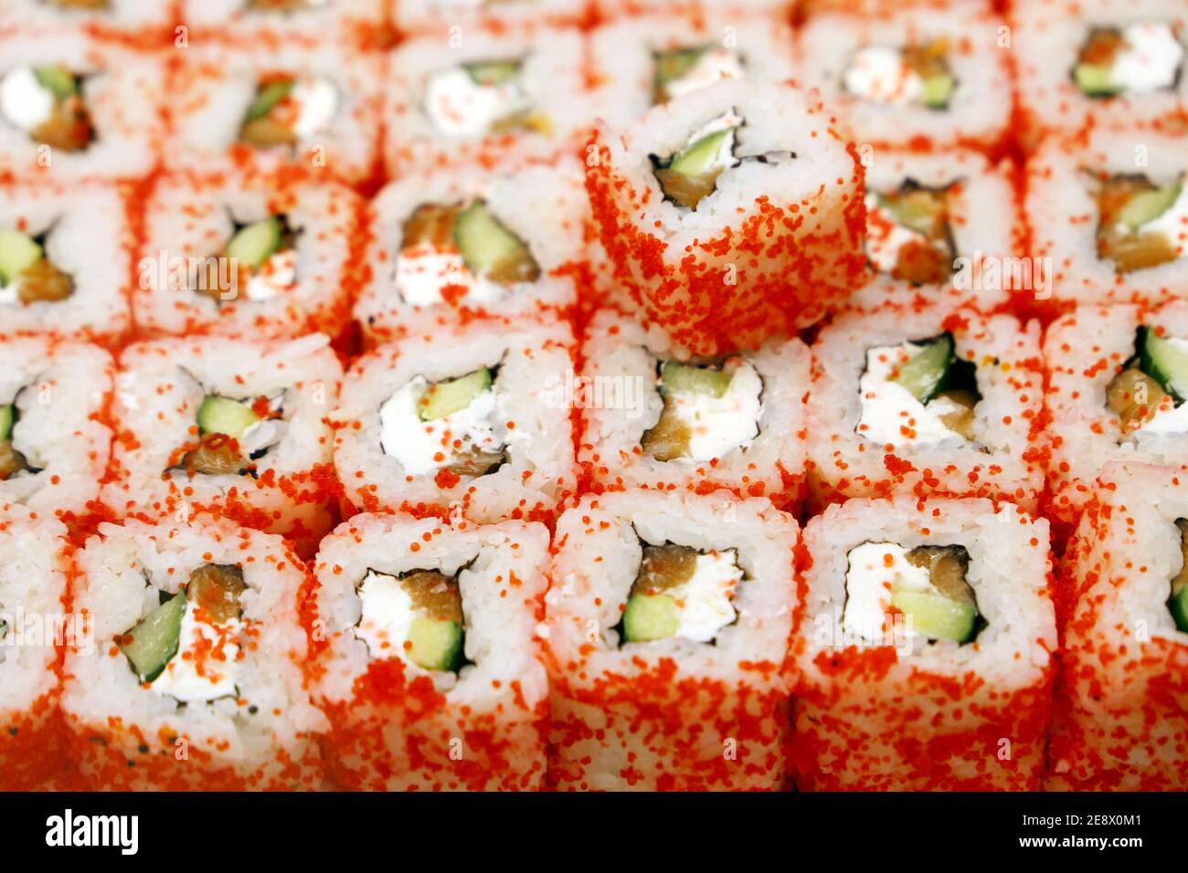 Sushi rolls with eel, cucumber and cream cheese, sprinkled with flying