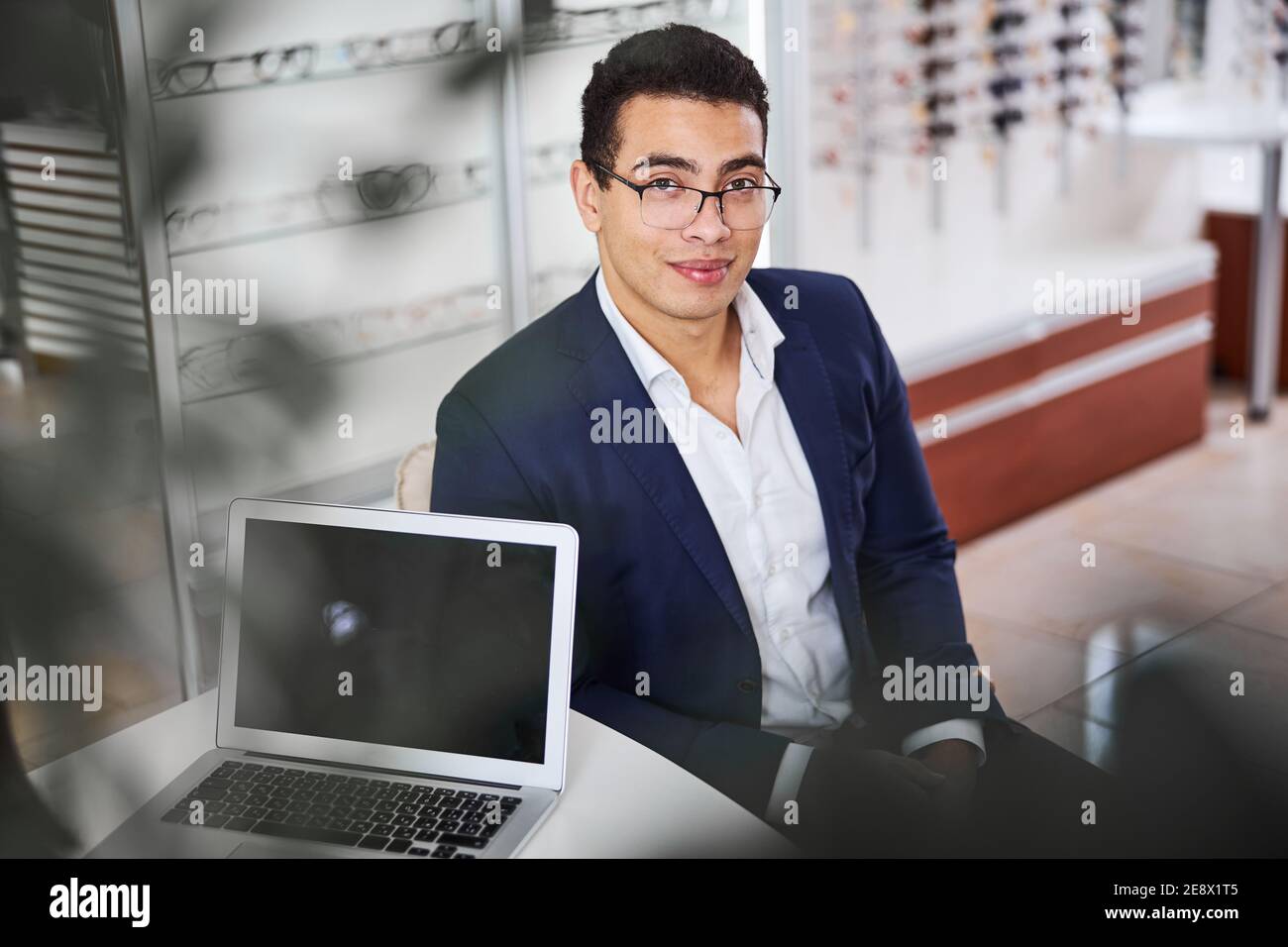 Serene male client seated in an optical store Stock Photo