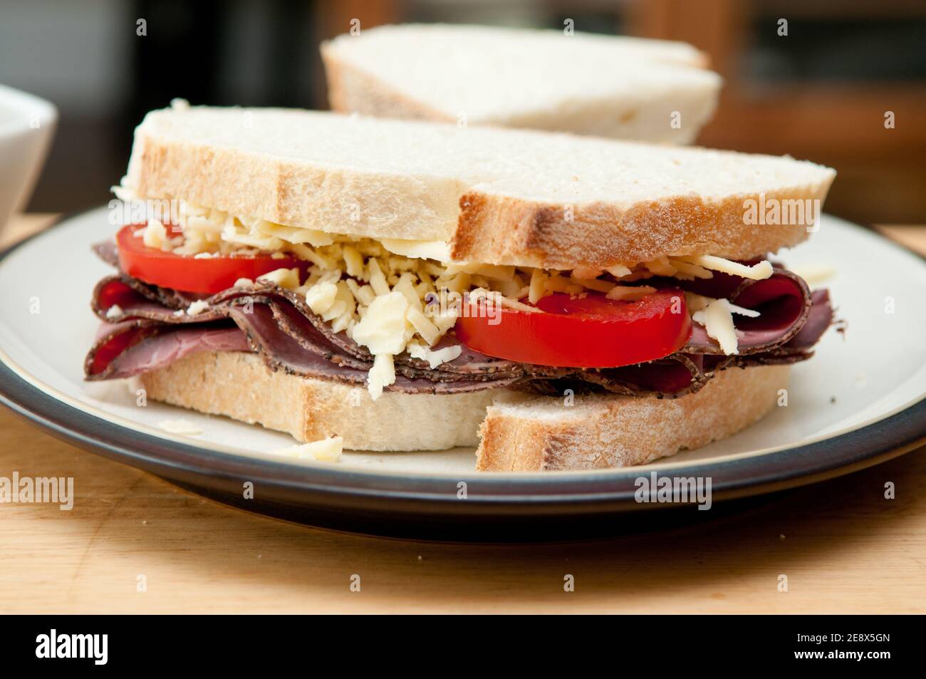 sliced roast beef sandwich, cheese and tomato and cole slaw Stock Photo