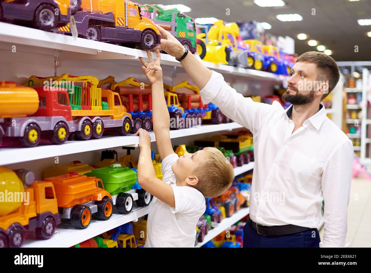 Father and son purchase a toy car in a toy store Stock Photo Alamy