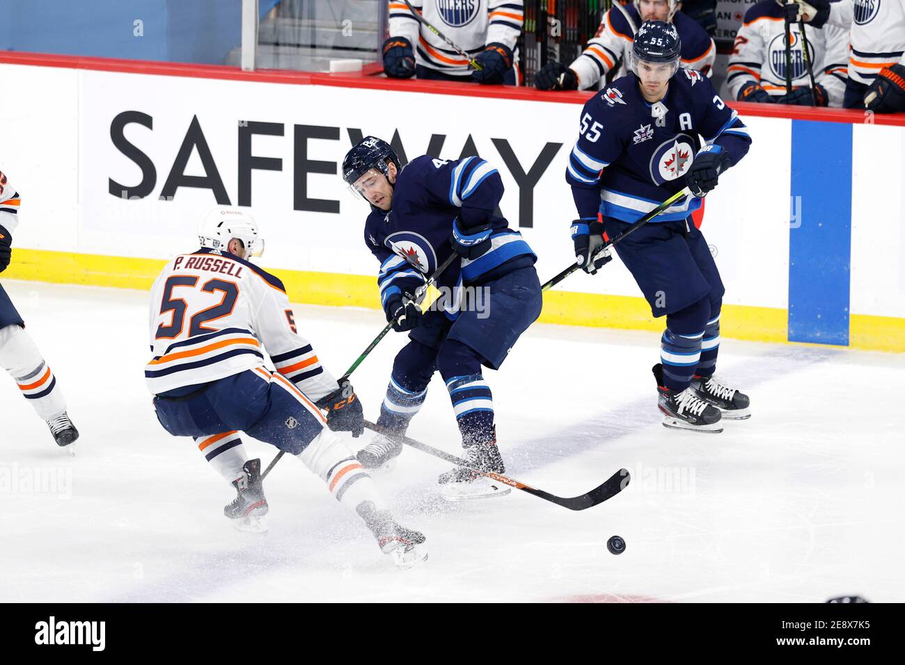 Winnipeg Jets defenseman Neal Pionk (4), Vegas Golden Knights center Nolan  Patrick (41), and Winnipeg Jets center Paul Stastny (25) compete for the  puck during the second period of an NHL hockey