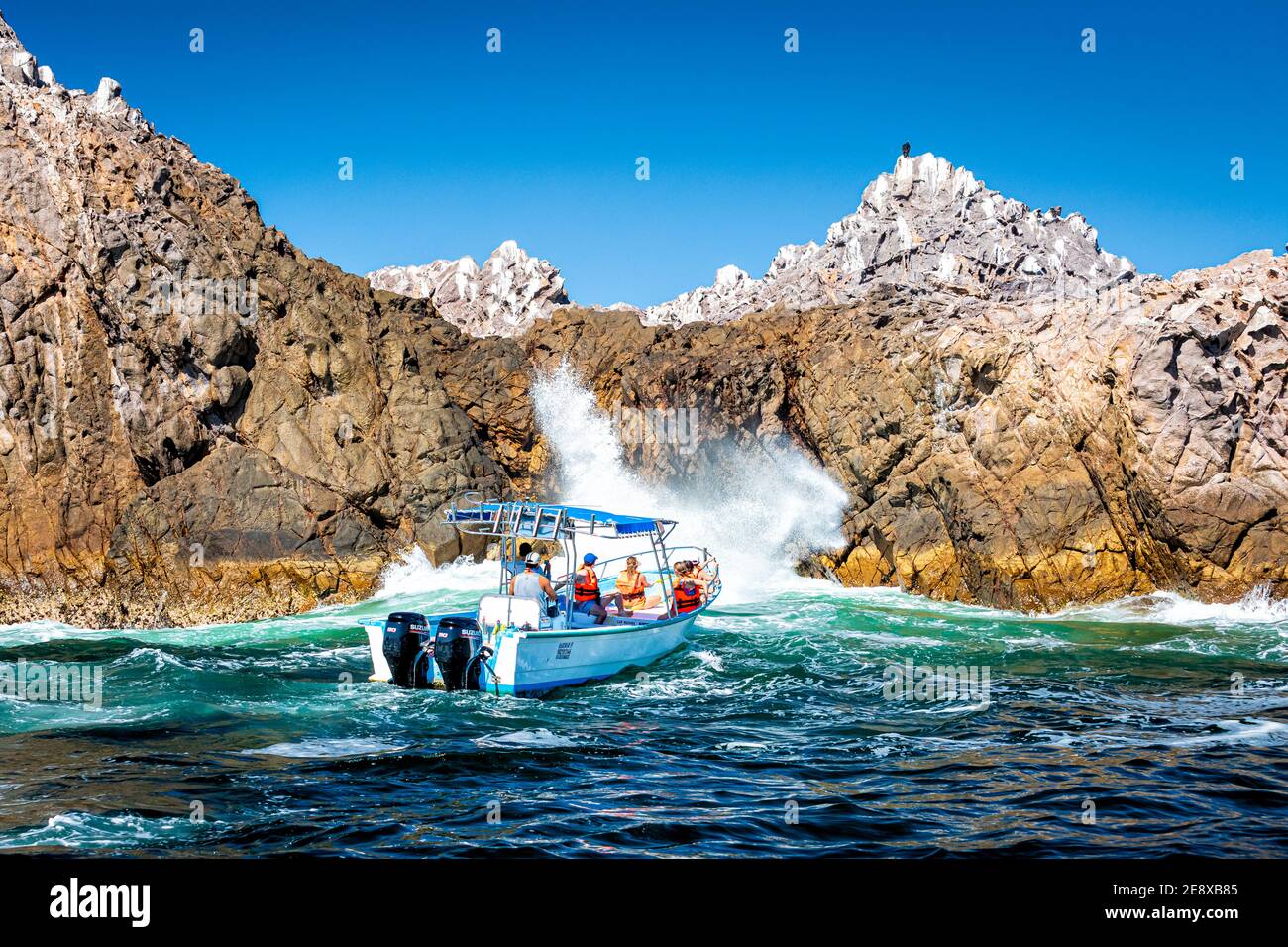 A tour boat circles the Marietas Islands off the Pacific Coast of Nayarit, Mexico. Stock Photo