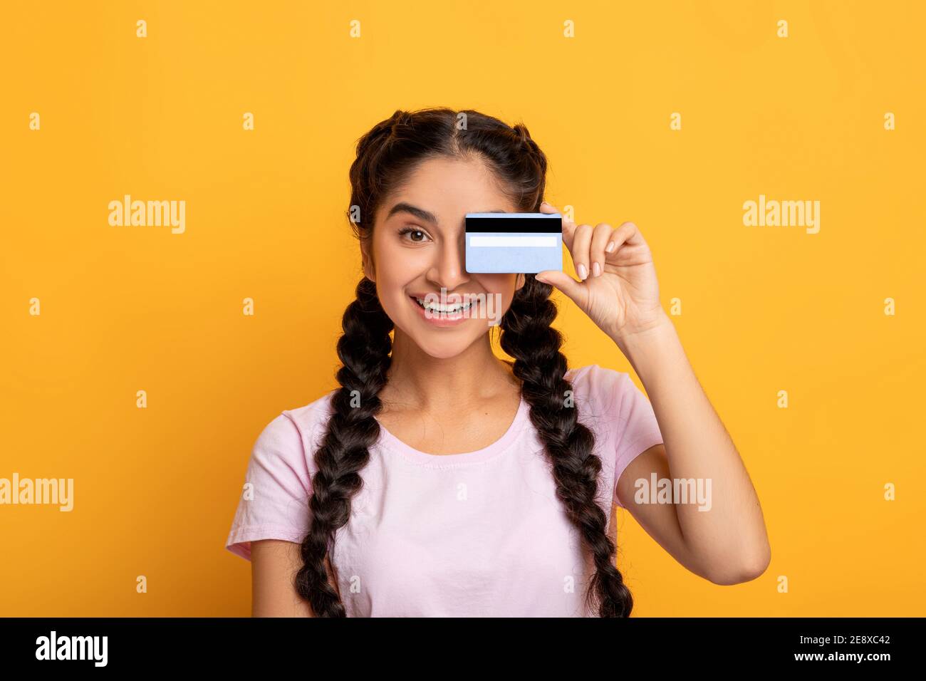 Indian lady holding plastic credit card covering eye Stock Photo - Alamy