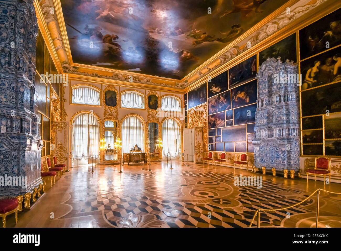 An ornate golden interior ballroom picture hall with inside the Rococo Catherine Palace near St. Petersburg, Russia. Stock Photo