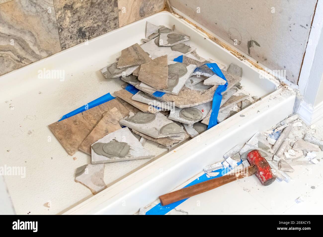Construction and demo work on a tiled shower tub in a bathroom of a residential home. Stock Photo