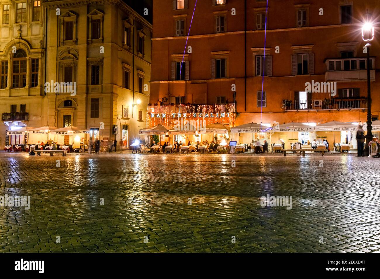 Illuminated cafes and restaurants with tourists late night at the Piazza Navona in Rome, Italy. Stock Photo