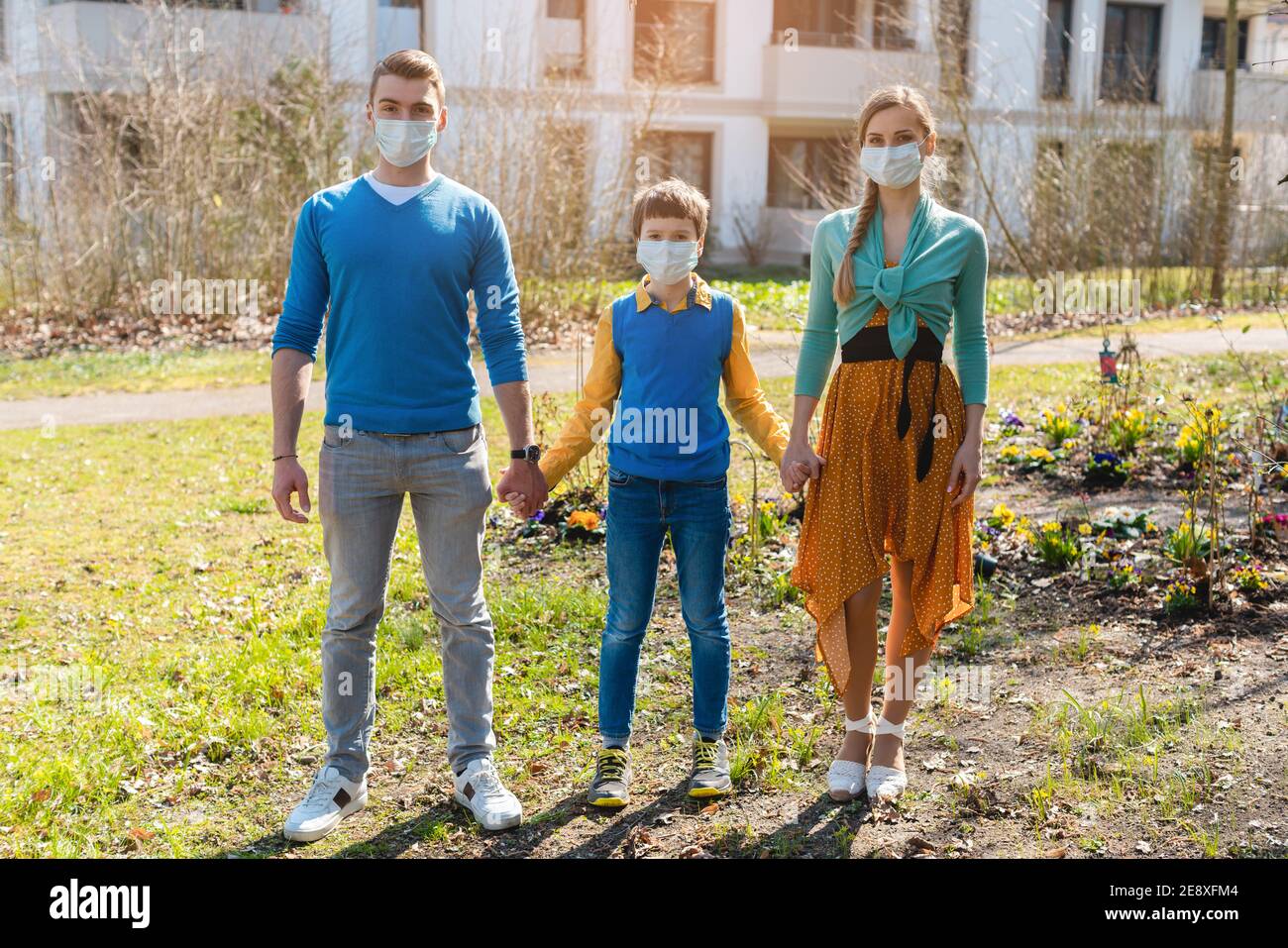 Family during coronavirus crises having a walk Stock Photo