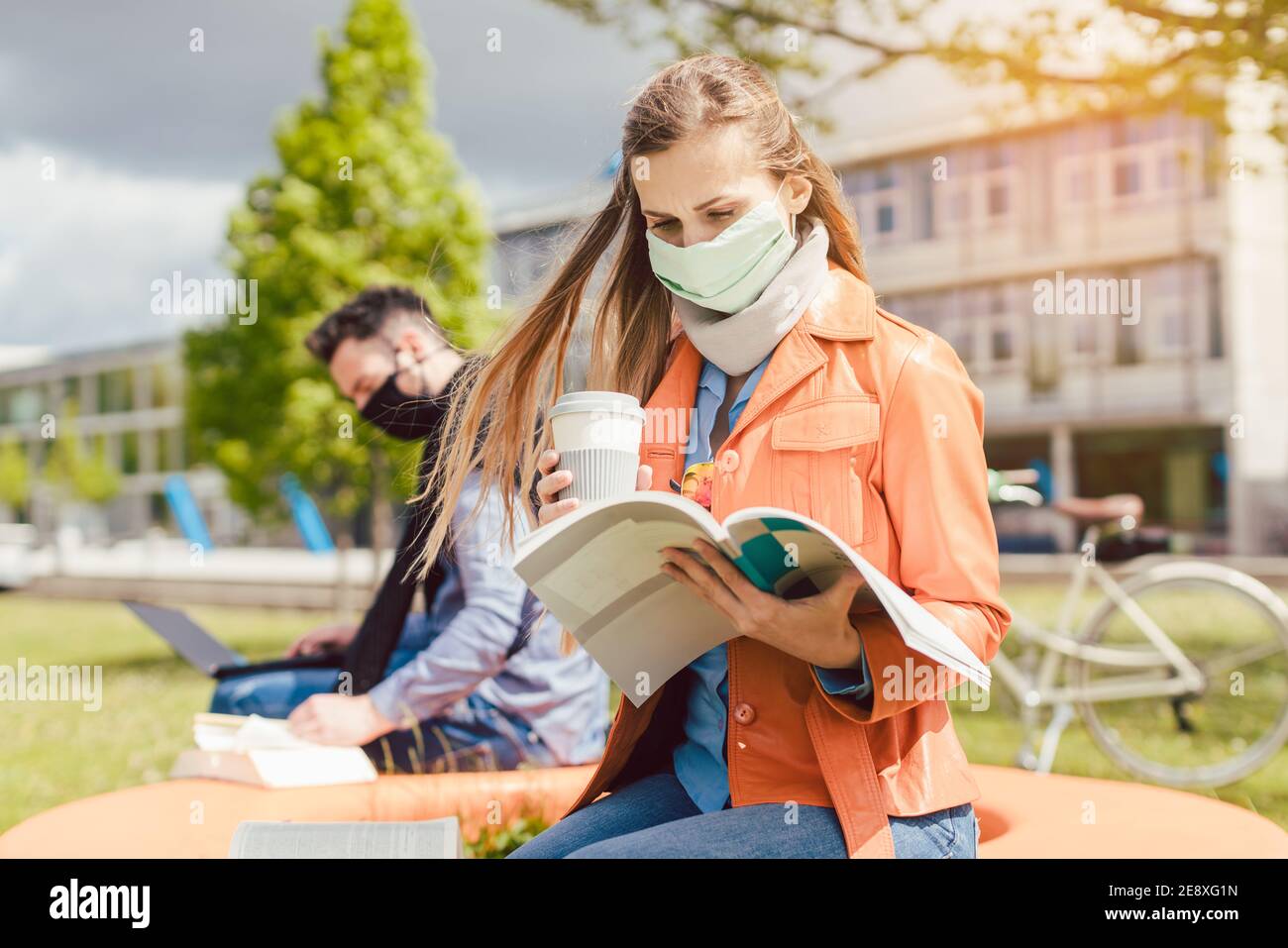 Woman student on college campus learning wearing face mask Stock Photo