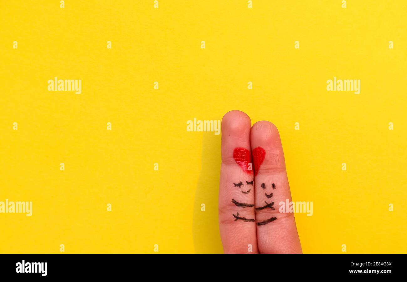 Valentines Day background. A happy couple with Red heart art on finger ...