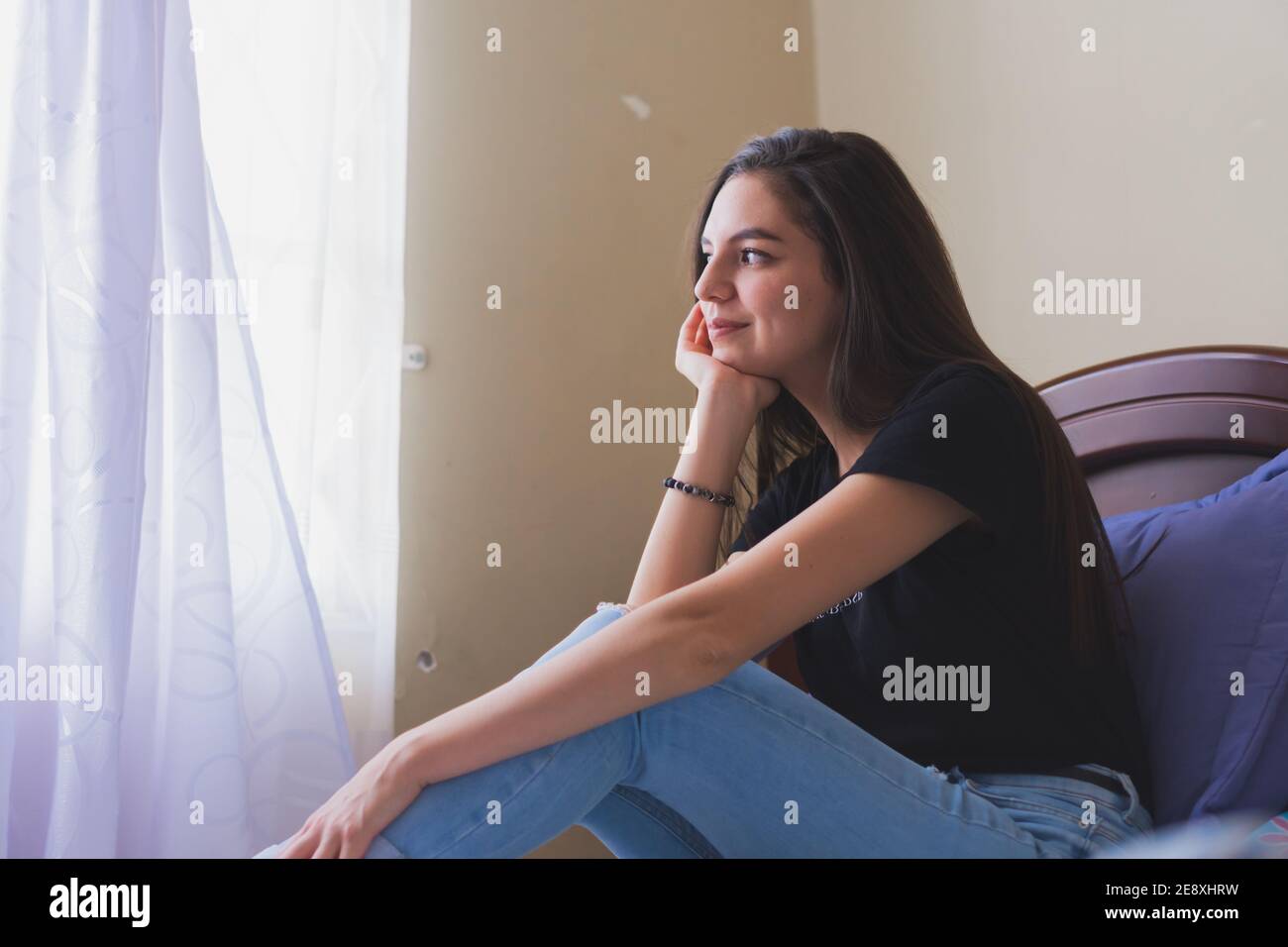 Young woman having a nice time. In his room remembering happy moments. Stock Photo