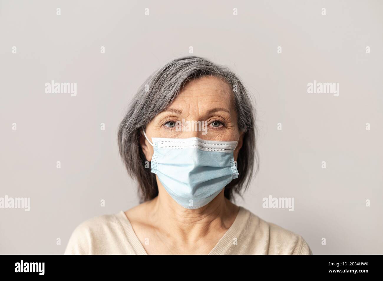 Mature woman wearing facial mask hi-res stock photography and images ...