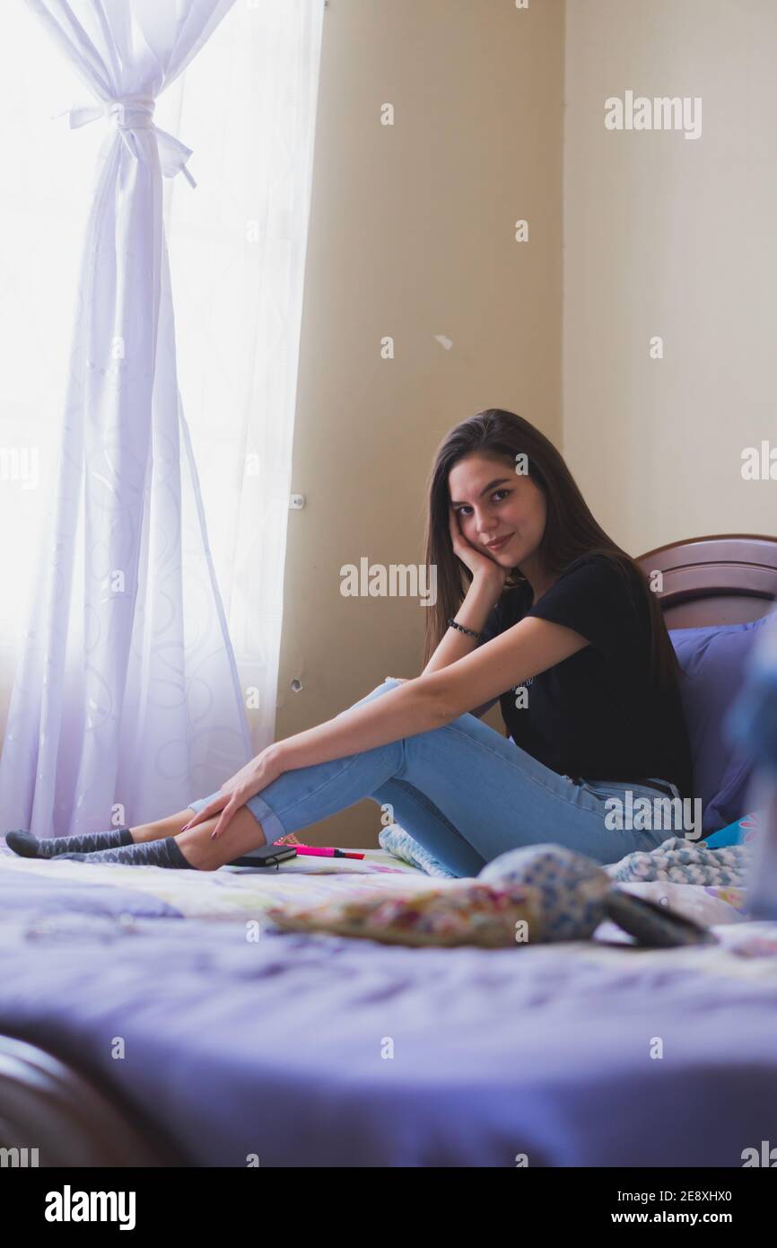 Young woman having a nice time. In his room remembering happy moments. Stock Photo