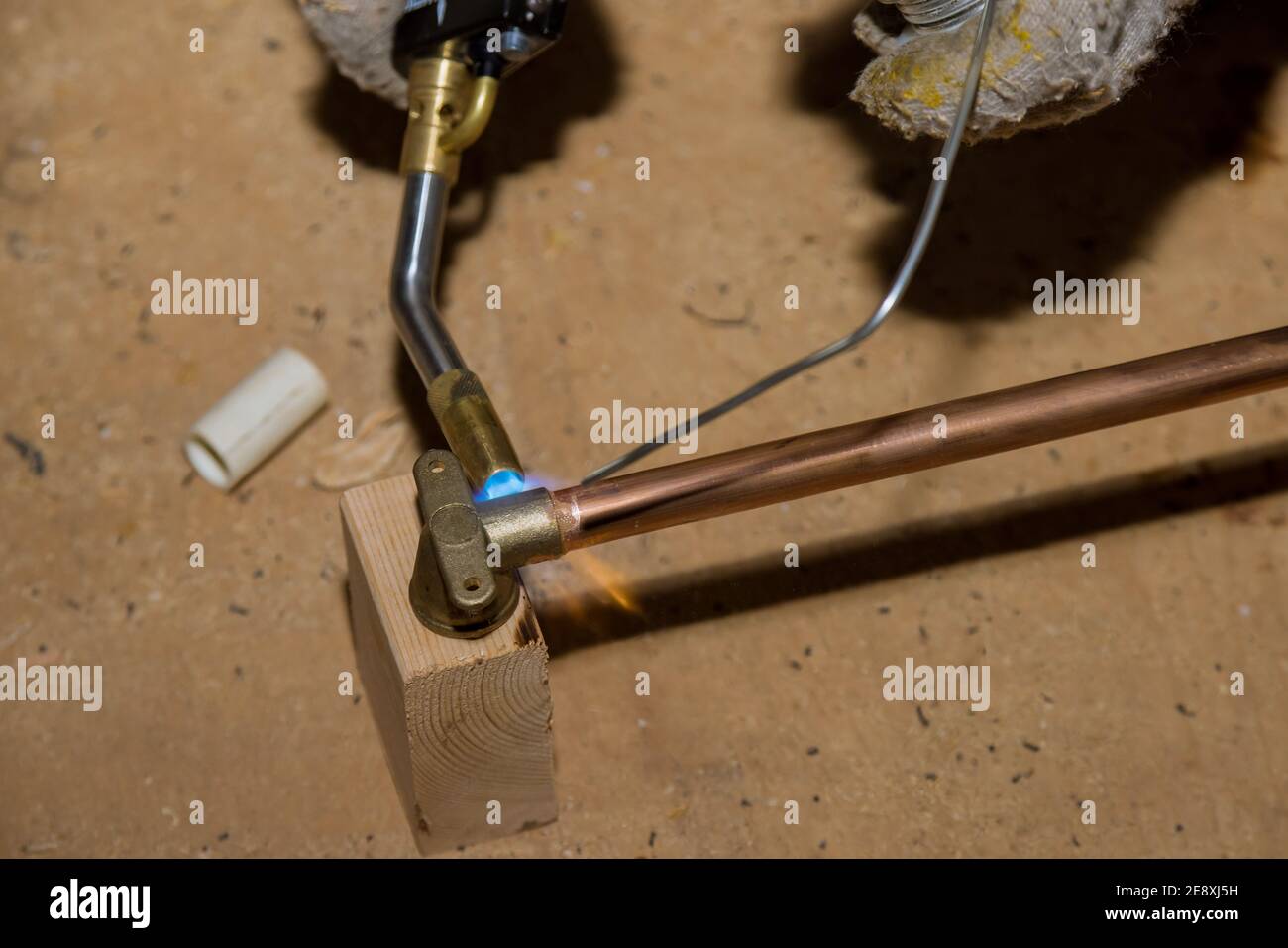 Soldering brass fitting on copper pipe with torch of welding on water  system Stock Photo - Alamy