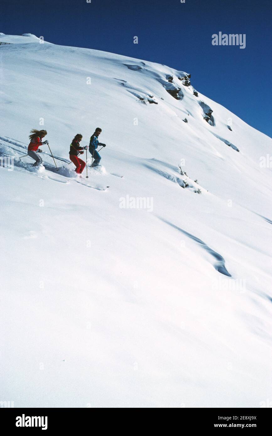 Australia. Three people downhill skiing in powder snow. Stock Photo