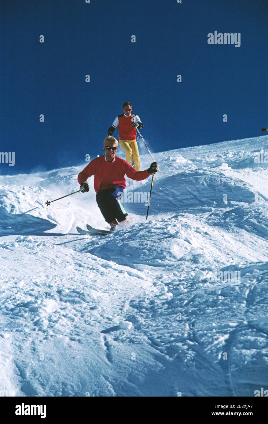 Australia. Snow skiing. Young men downhill skiing. Stock Photo