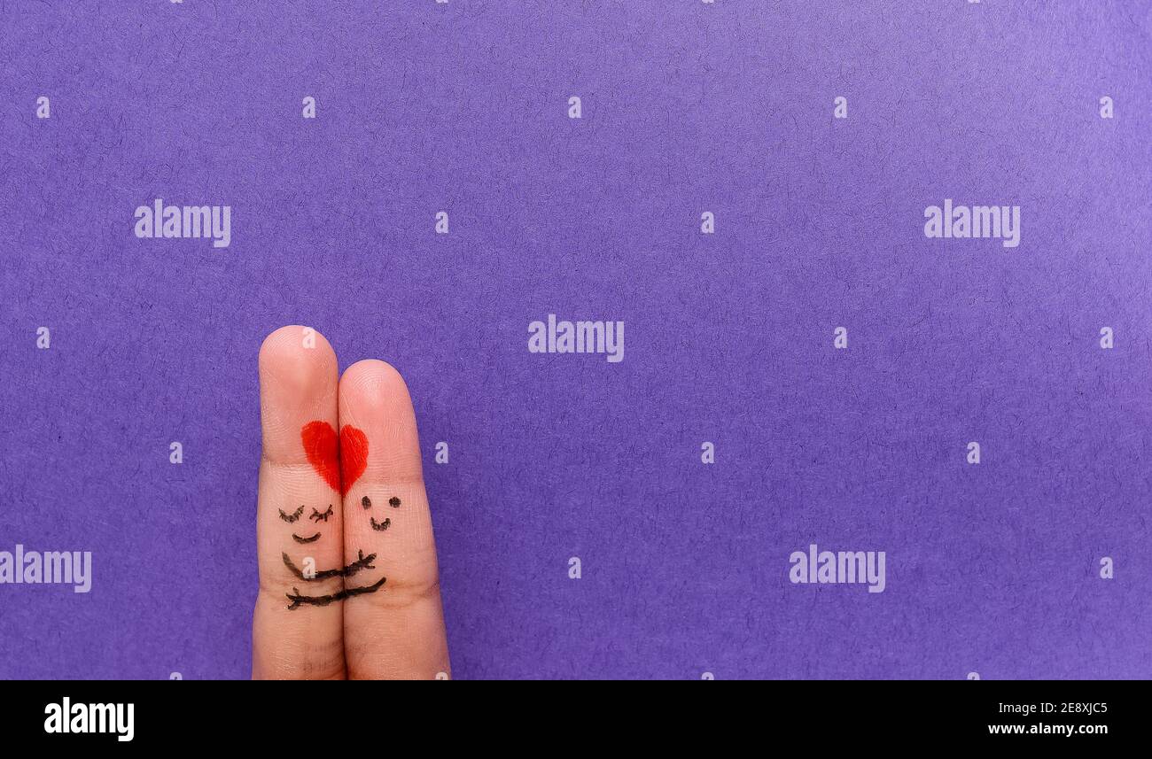 Valentines Day background. A happy couple with Red heart art on finger ...