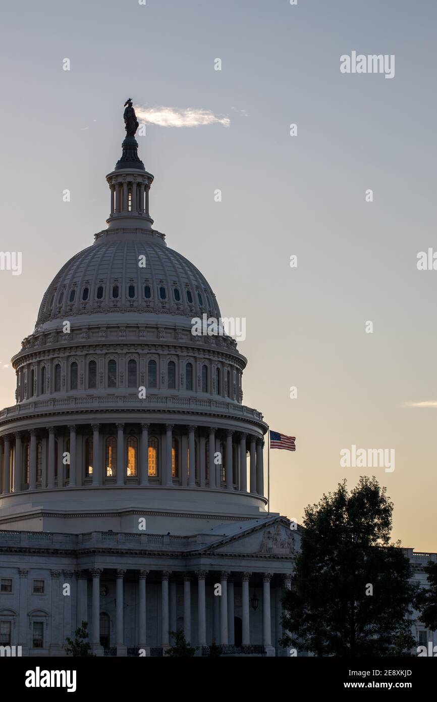 United States flag flying on the US Capitol as sunset in Washington DC. Stock Photo