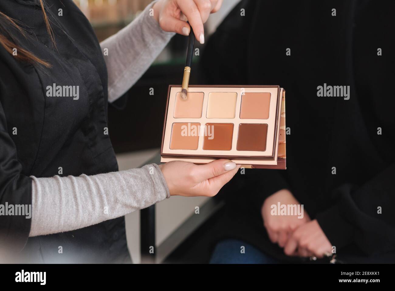 Female makeup artist show with color of palette will use. Makeup artist