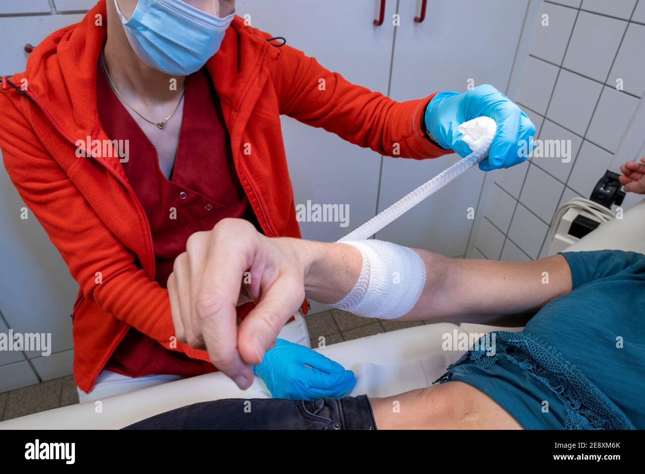 Schwerin, Germany. 08th Dec, 2020. A nurse is applying a bandage to a patient in one of the treatment rooms of a family doctor's office. Credit: Jens Büttner/dpa-Zentralbild/ZB/dpa/Alamy Live News Stock Photo