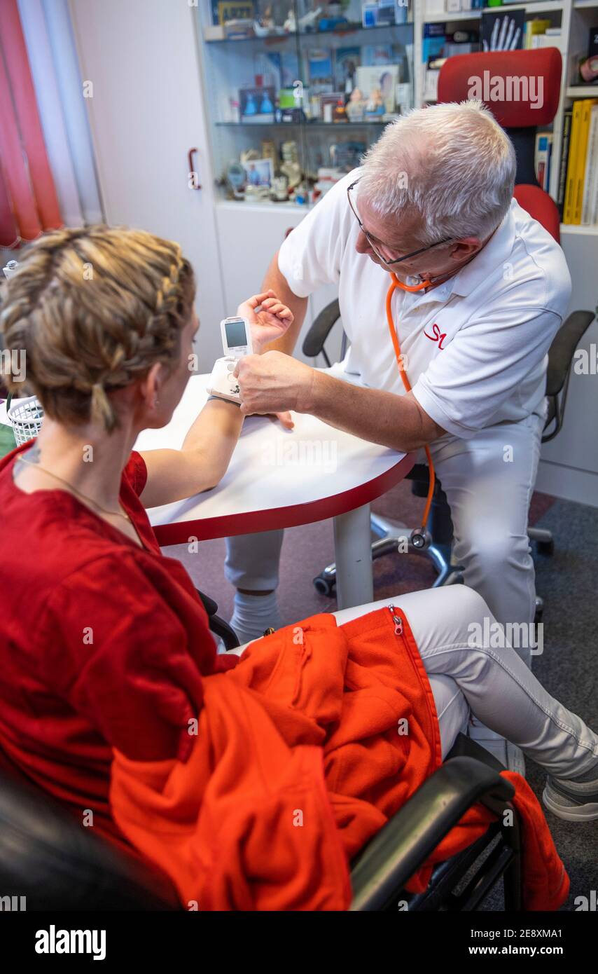 Schwerin, Germany. 08th Dec, 2020. Siegfried Mildner measures the blood pressure of a patient in one of the treatment rooms of a family doctor's practice. Credit: Jens Büttner/dpa-Zentralbild/ZB/dpa/Alamy Live News Stock Photo