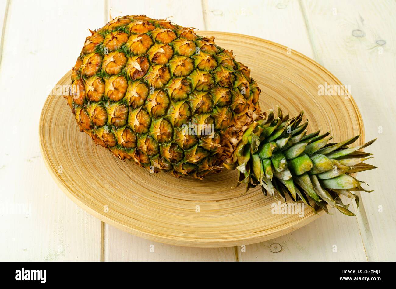 Exotic fruits. Ripe sweet ripe pineapple on wooden background. Photo Stock Photo