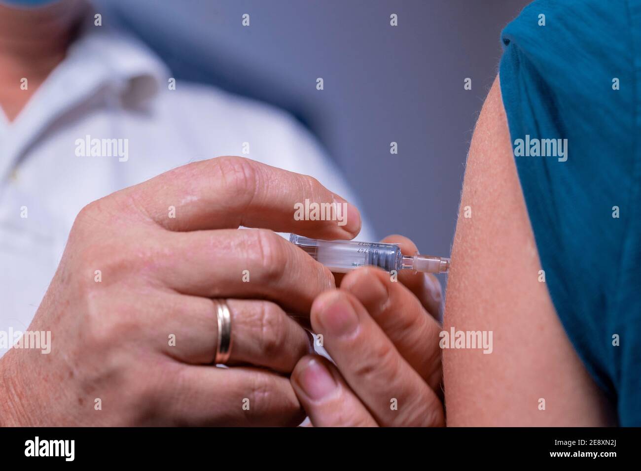 Schwerin, Germany. 08th Dec, 2020. Siegfried Mildner gives a vaccination to a patient in one of the treatment rooms of a family doctor's practice. Credit: Jens Büttner/dpa-Zentralbild/ZB/dpa/Alamy Live News Stock Photo