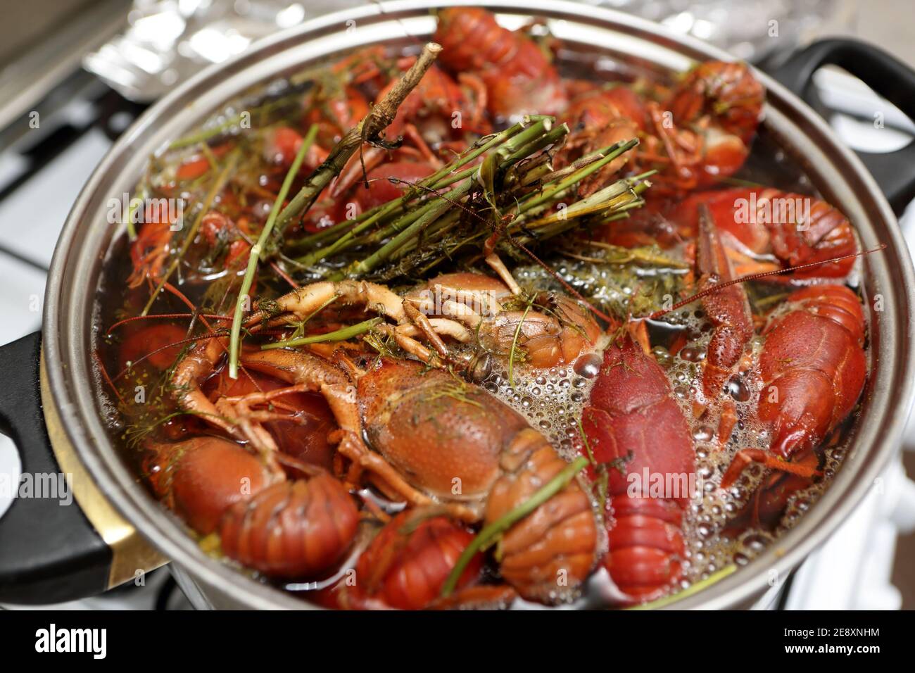 Cooking of crayfish with herb at a kitchen Stock Photo