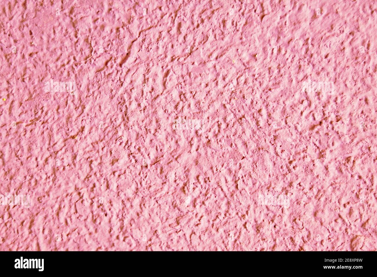 Abstract grainy texture on light pink wall. Design element and background Stock Photo